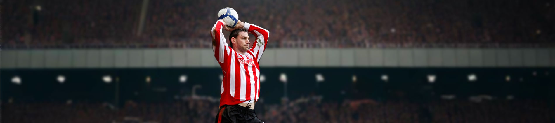 A soccer plaer taking a throw in
